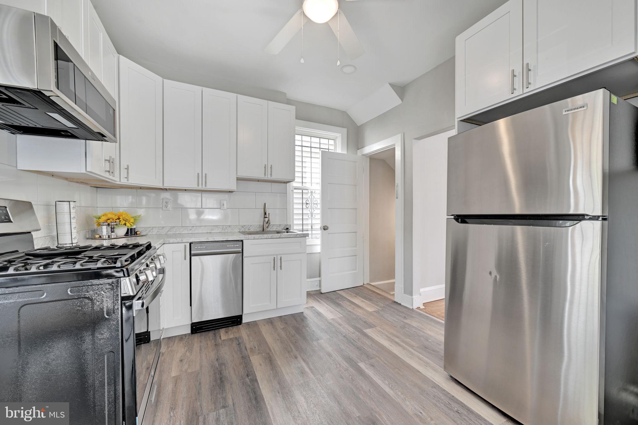 3005 7th Street Southeast Washington, DC 20032 - Photo 16 of 56 a kitchen with a refrigerator a stove a microwave and cabinets