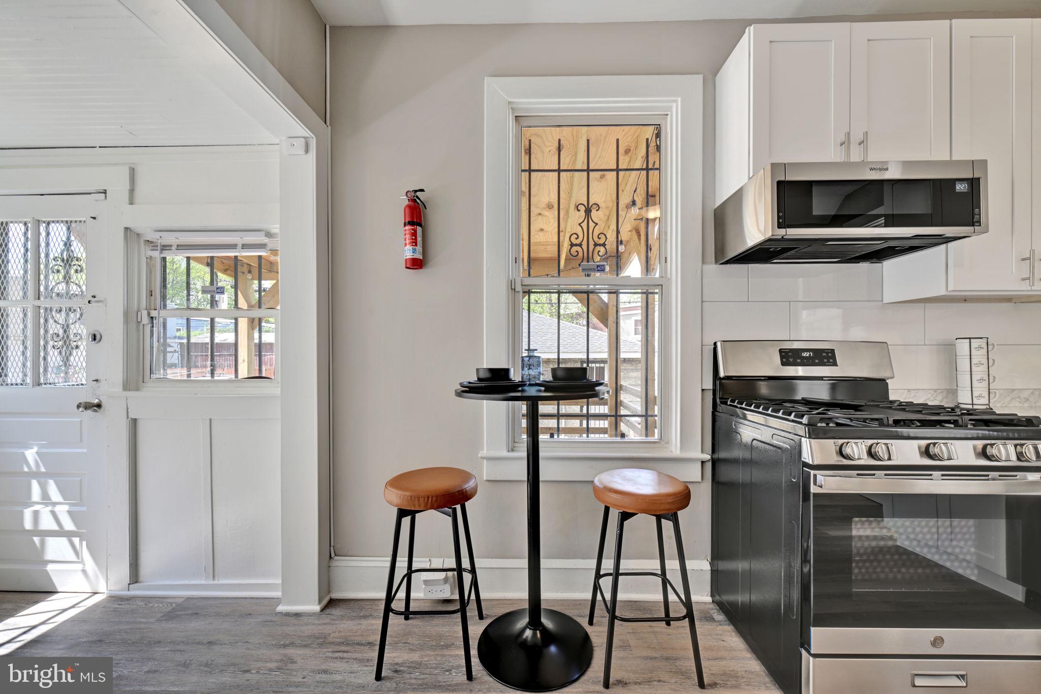 3005 7th Street Southeast Washington, DC 20032 - Photo 21 of 56 a kitchen with stainless steel appliances granite countertop a stove a sink and a microwave