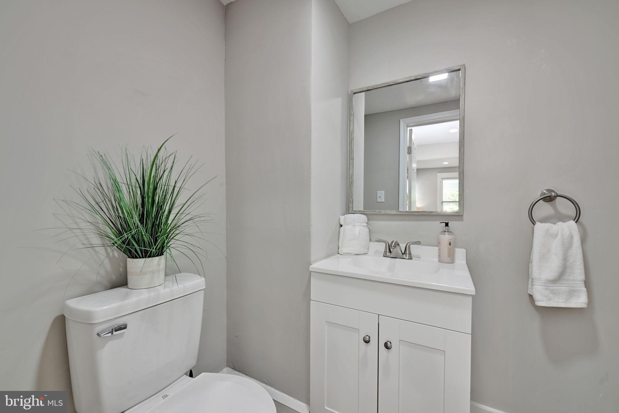 3005 7th Street Southeast Washington, DC 20032 - Photo 22 of 56 a bathroom with a toilet a sink and mirror