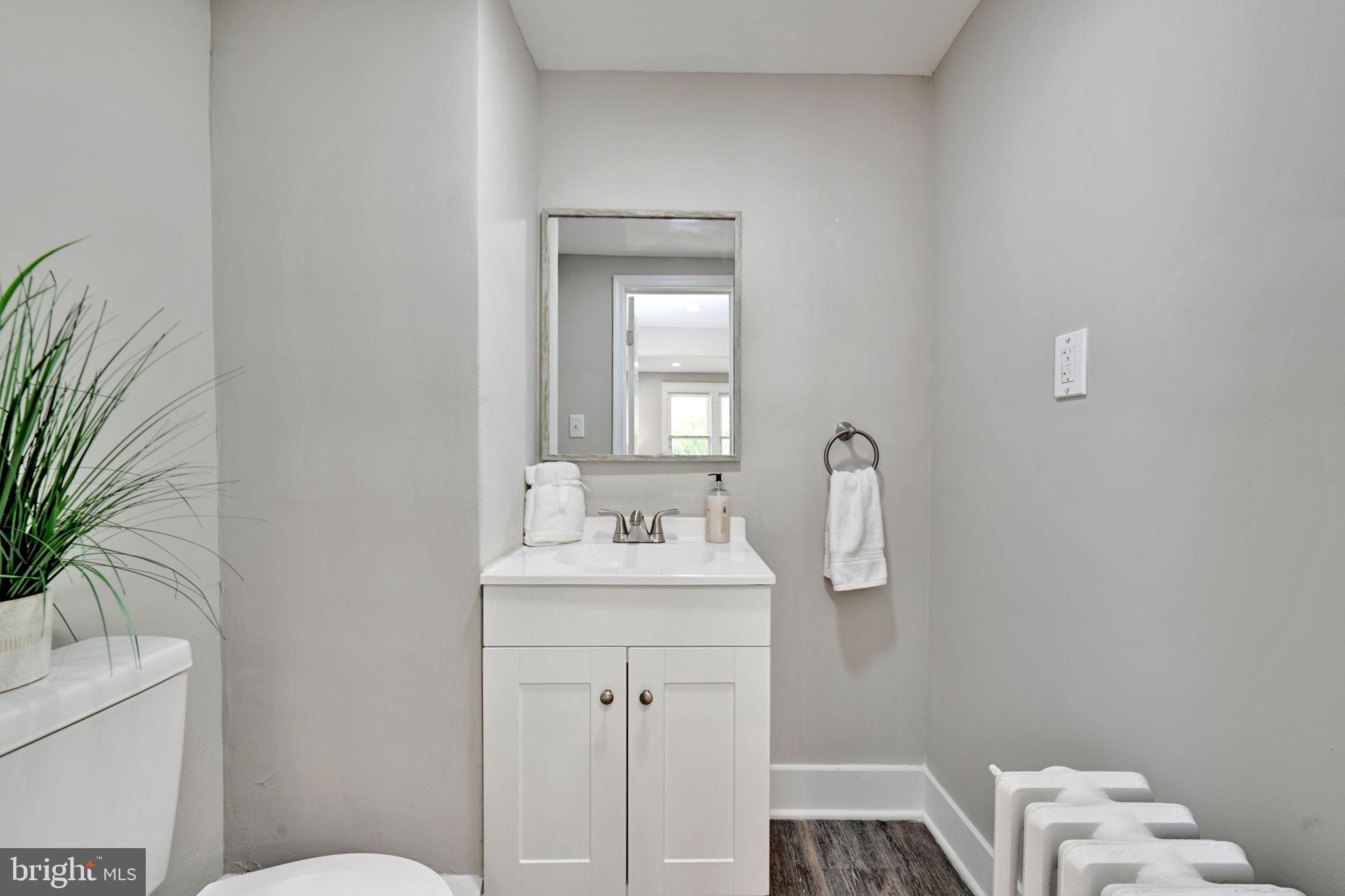 3005 7th Street Southeast Washington, DC 20032 - Photo 23 of 56 a bathroom with a toilet a sink and mirror
