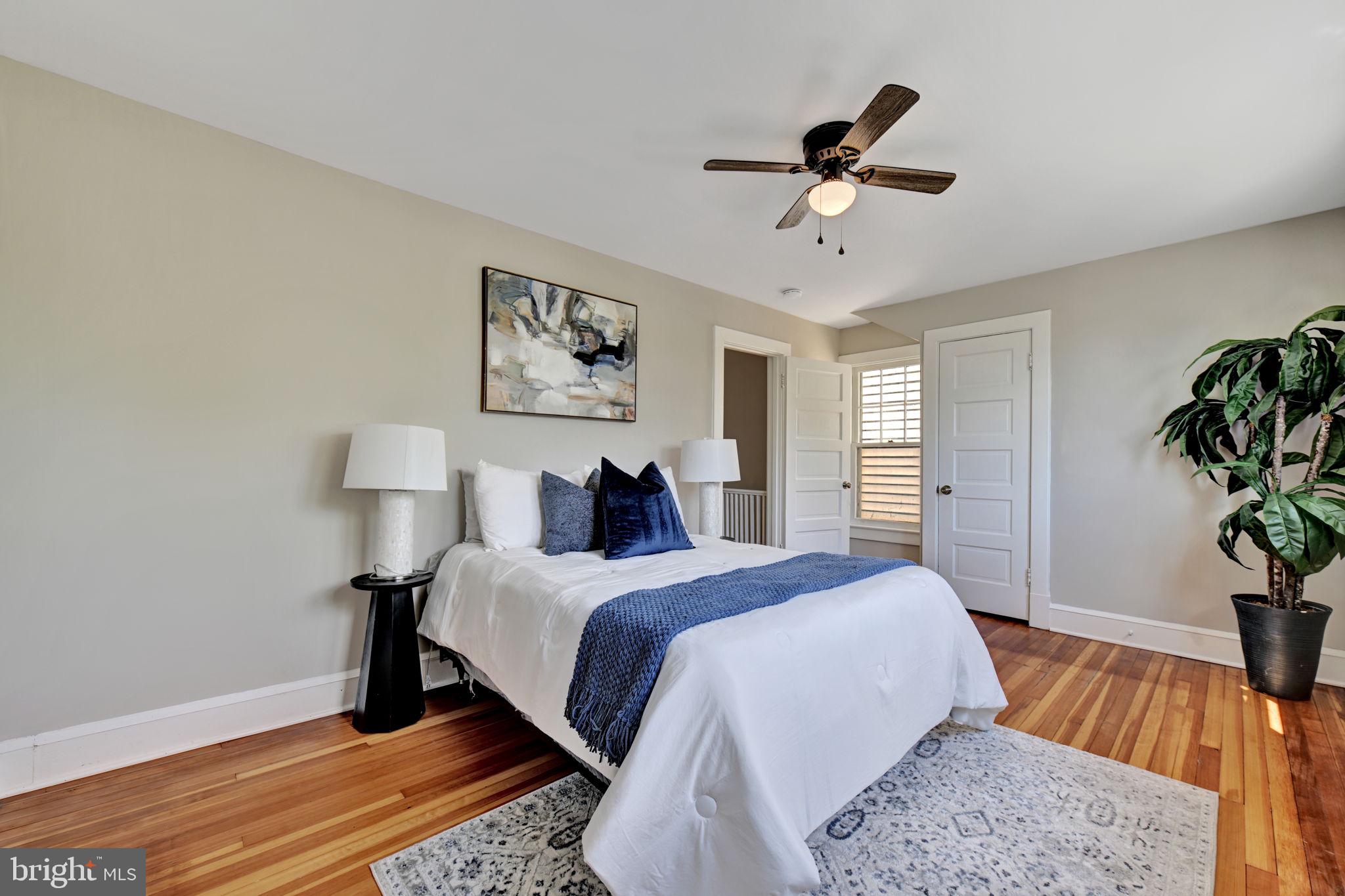 3005 7th Street Southeast Washington, DC 20032 - Photo 28 of 56 a bedroom with a bed and a potted plant