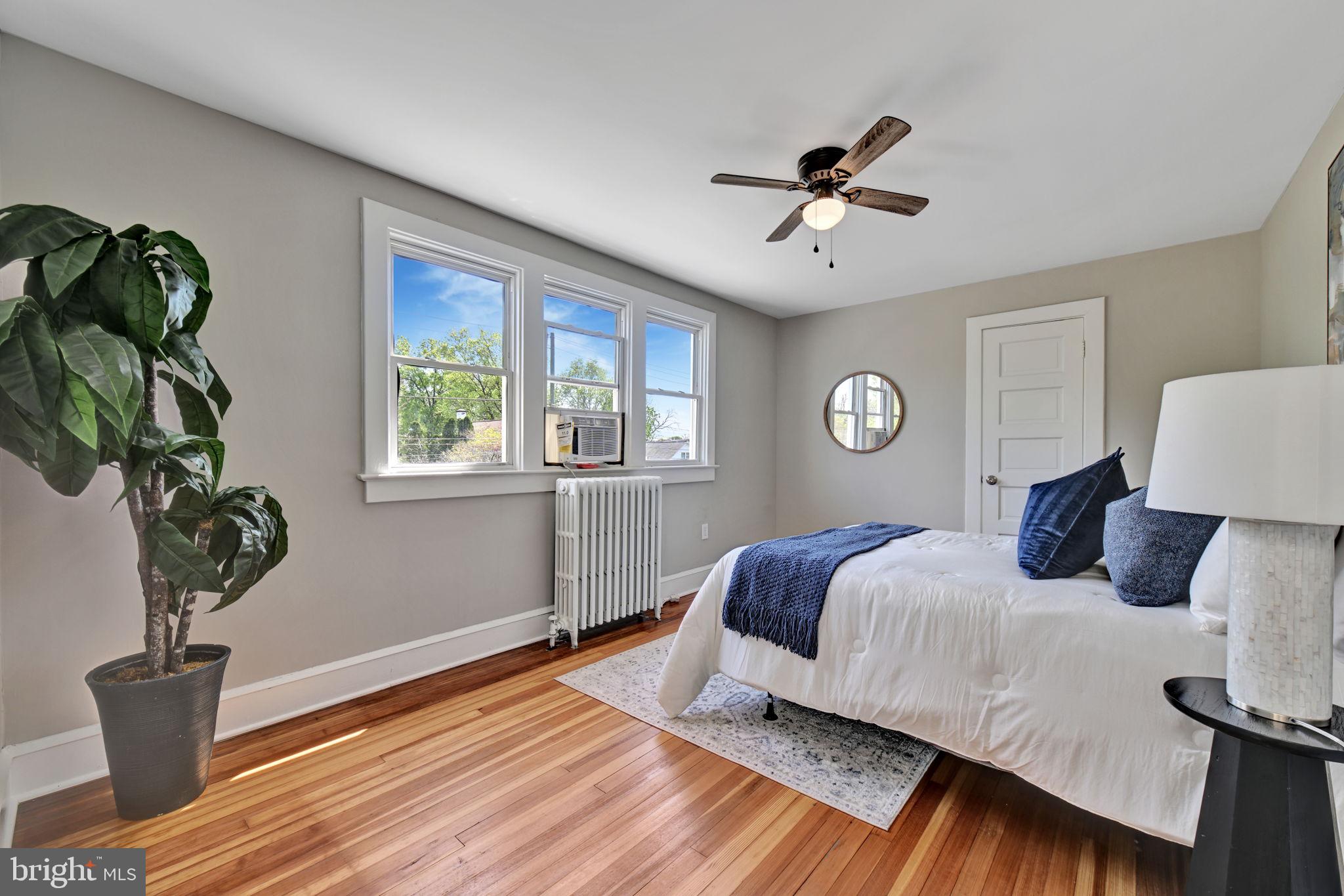 3005 7th Street Southeast Washington, DC 20032 - Photo 29 of 56 a bedroom with a bed and wooden floor