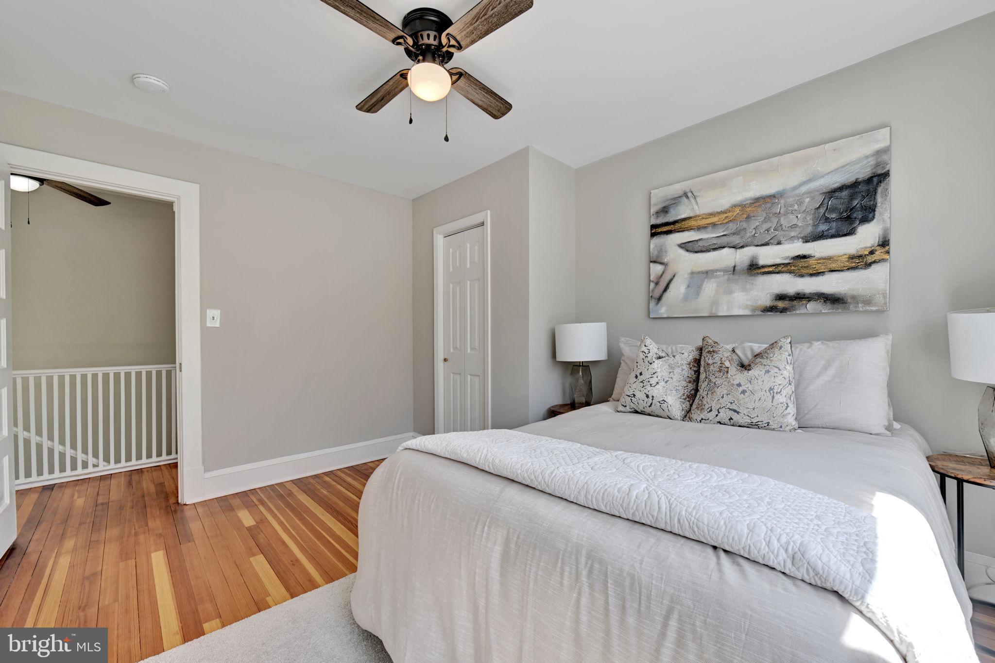 3005 7th Street Southeast Washington, DC 20032 - Photo 32 of 56 a bedroom with a large bed and a chandelier