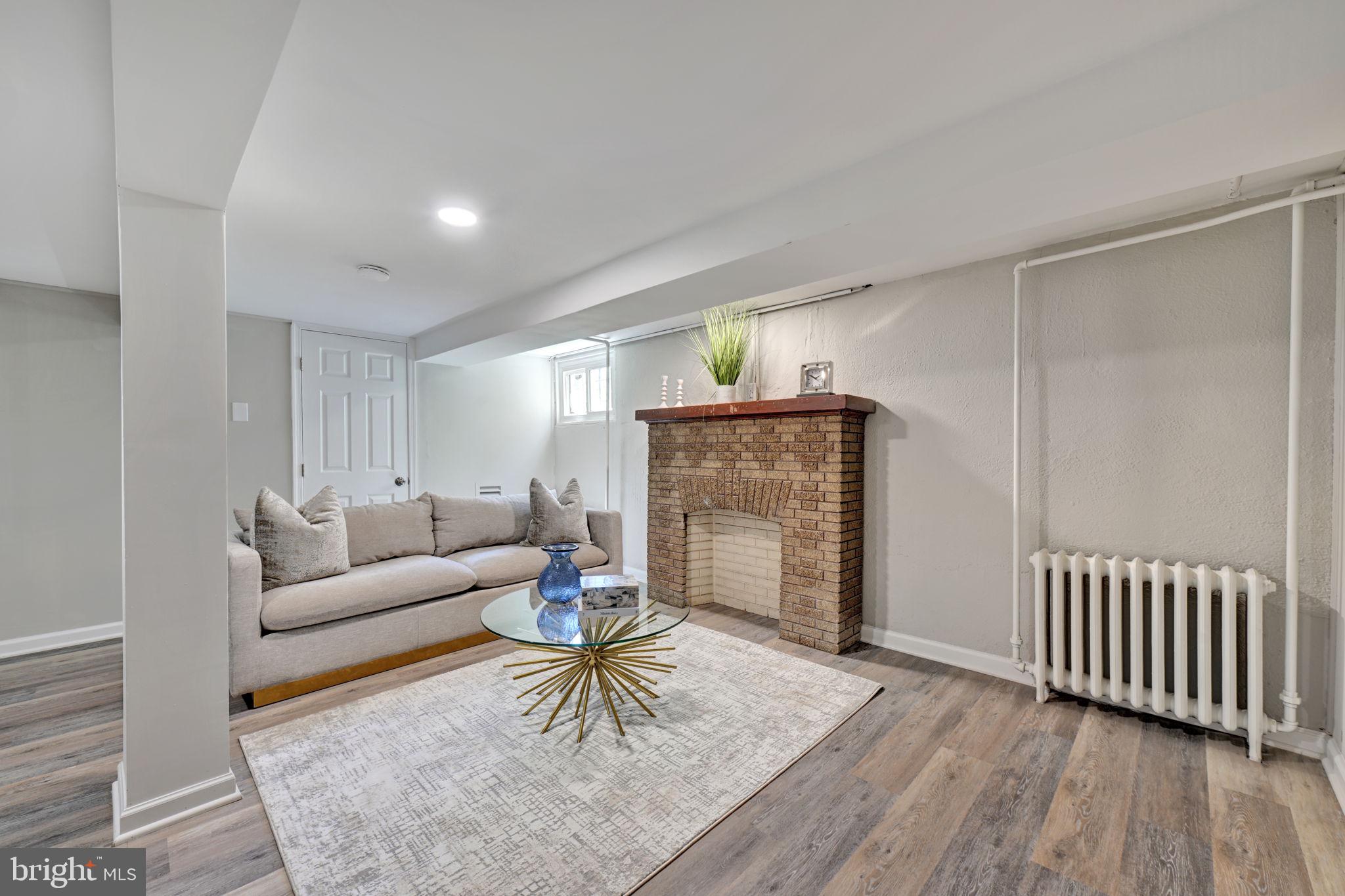3005 7th Street Southeast Washington, DC 20032 - Photo 38 of 56 a living room with furniture and a fireplace