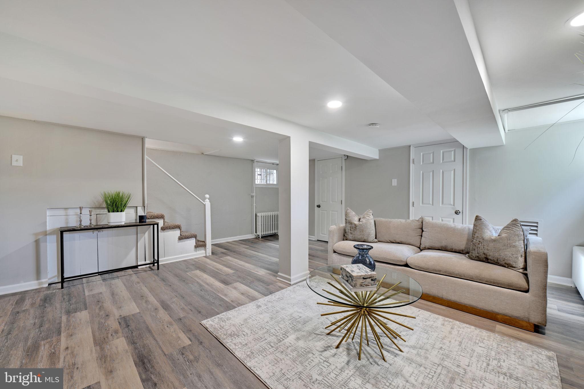 3005 7th Street Southeast Washington, DC 20032 - Photo 40 of 56 a living room with furniture and a wooden floor