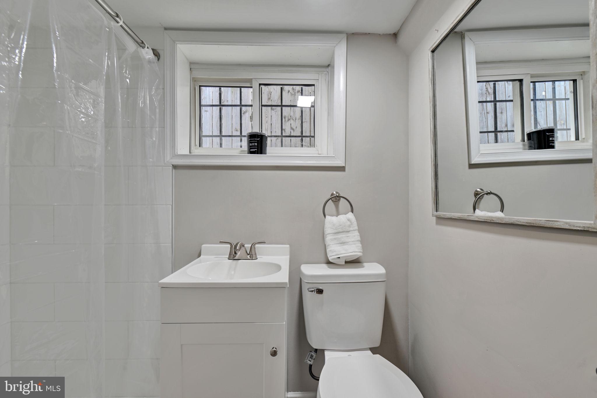 3005 7th Street Southeast Washington, DC 20032 - Photo 42 of 56 a bathroom with a toilet sink and mirror