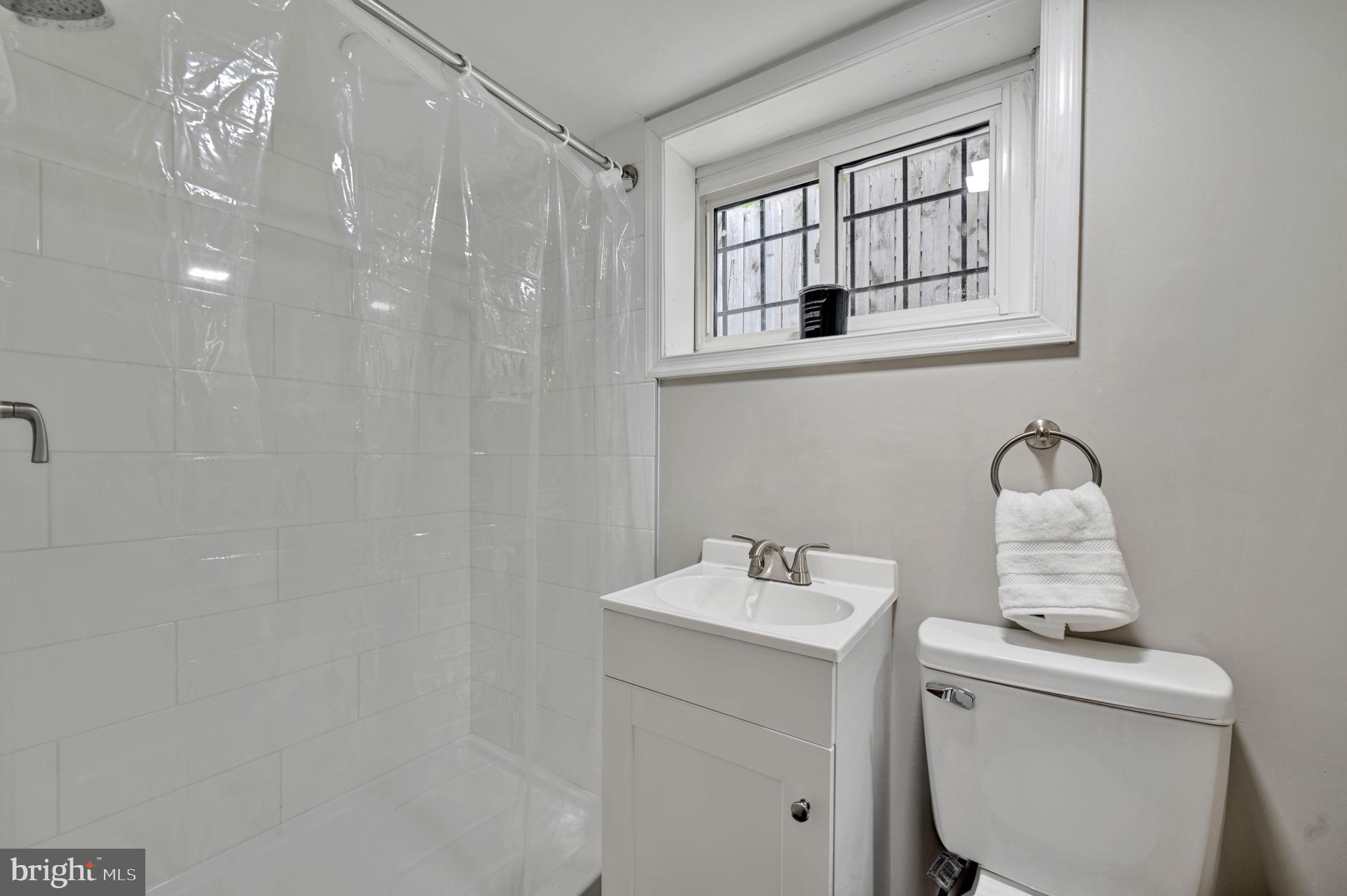 3005 7th Street Southeast Washington, DC 20032 - Photo 43 of 56 a bathroom with a sink mirror and toilet