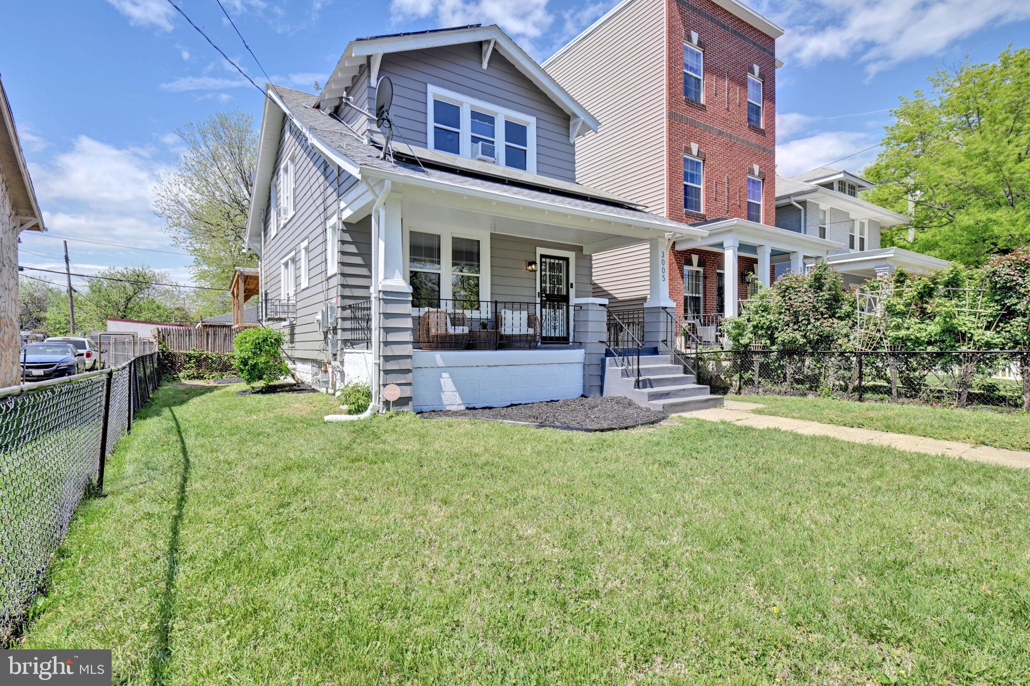 3005 7th Street Southeast Washington, DC 20032 - Photo 47 of 56 a front view of a house with garden and porch