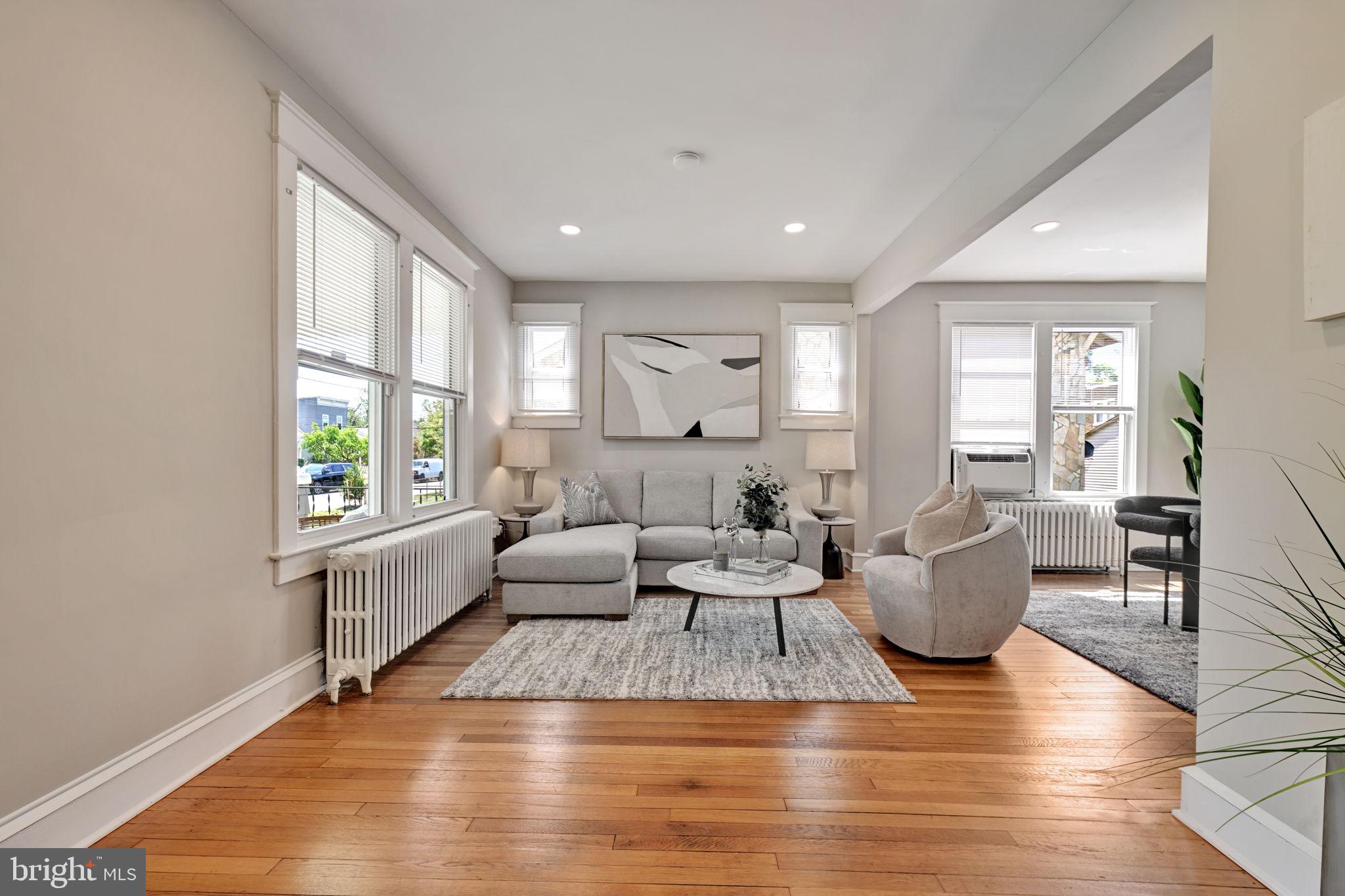3005 7th Street Southeast Washington, DC 20032 - Photo 7 of 56 a living room with furniture large window and wooden floor