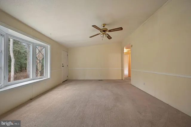 an empty room with a empty space and windows