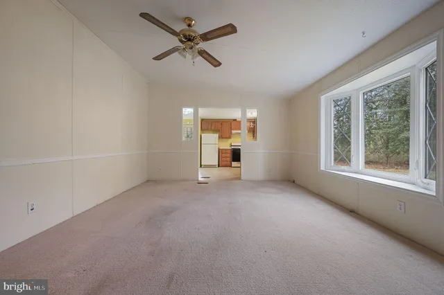 an empty room with a empty space and windows