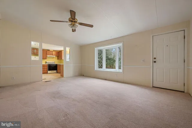 a view of a livingroom with an empty space and a window