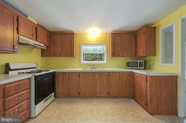 a kitchen with a stove a sink and a microwave