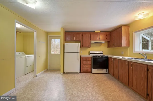 a kitchen with a refrigerator and a sink