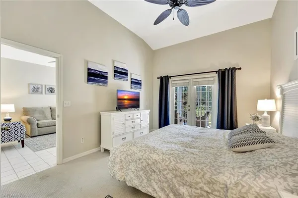 a bedroom with a large bed and a flat tv screen