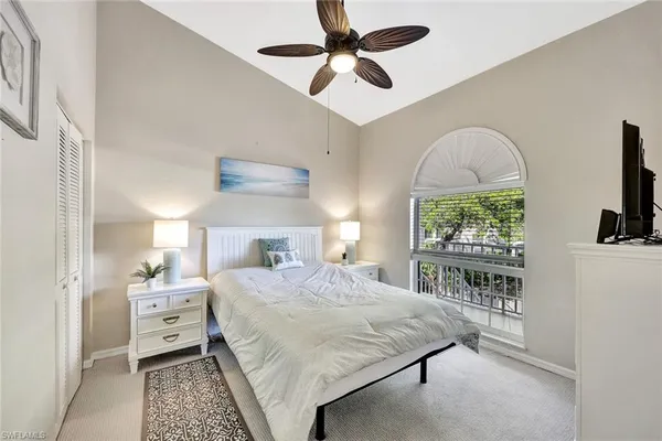 a bedroom with a bed and a large window