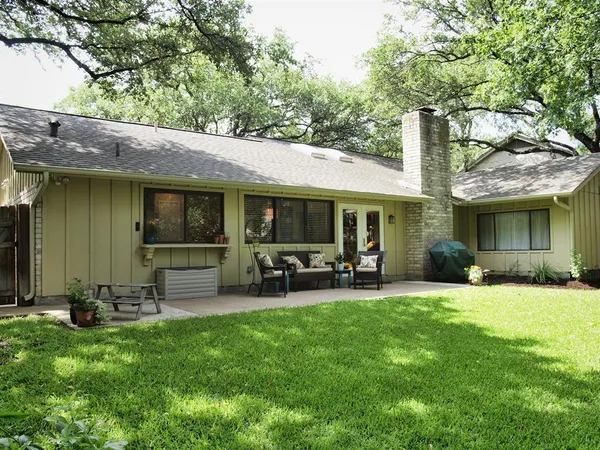 a front view of a house with sitting area and garden