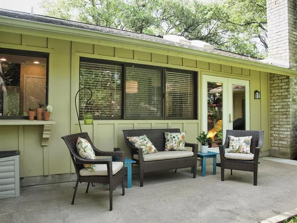 a balcony with furniture and a potted plant