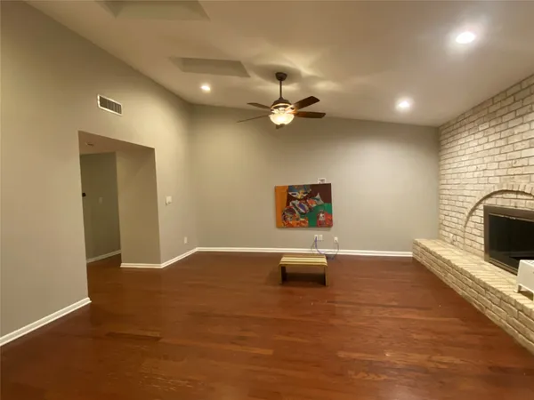 a view of an empty room with a fireplace