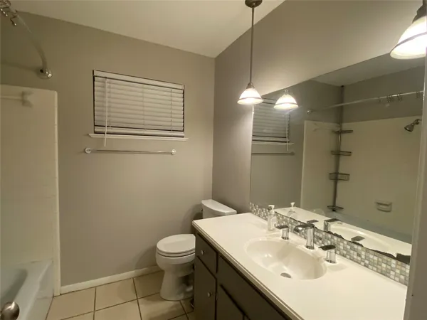 a bathroom with a sink toilet and vanity