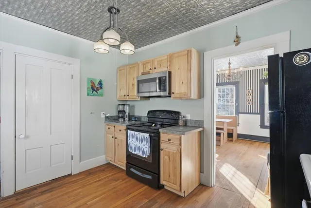 a kitchen with stainless steel appliances granite countertop a stove and a refrigerator