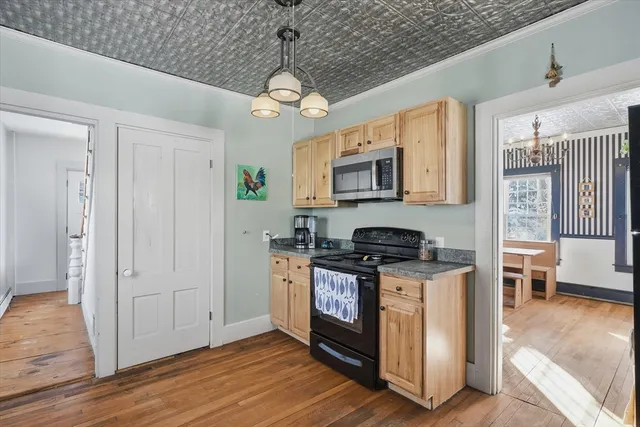 a kitchen with stainless steel appliances granite countertop a stove a refrigerator and a microwave