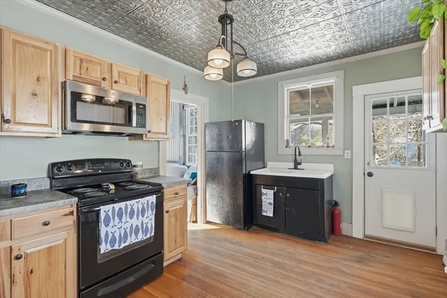 a kitchen with stainless steel appliances granite countertop a stove and a refrigerator