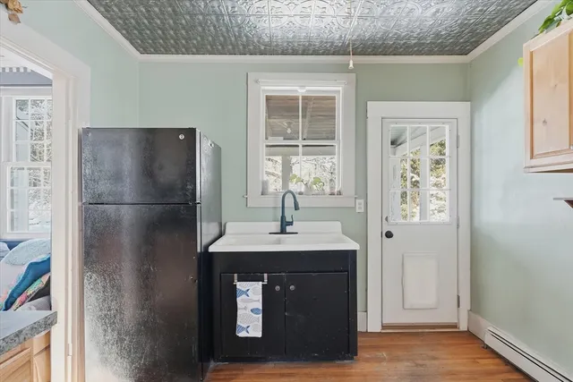 a kitchen with a refrigerator and a sink