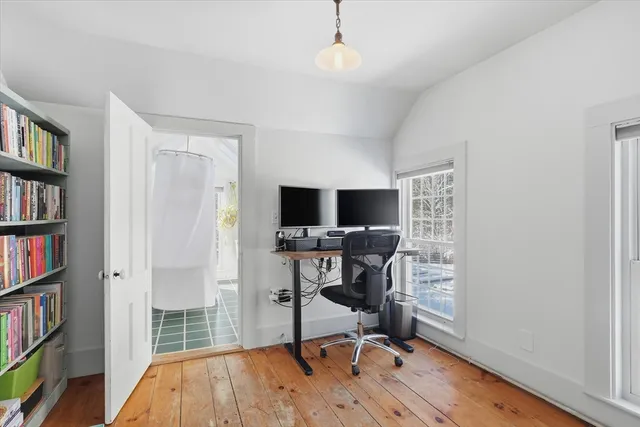 a view of a workspace with furniture and a bookshelf