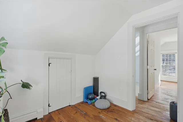 a view of a bedroom with wooden floor and closet