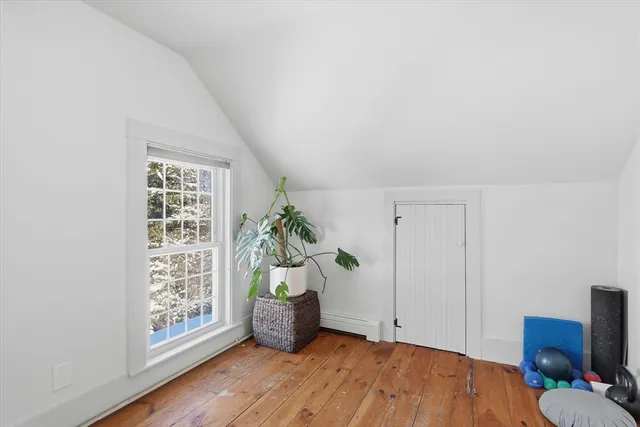 a view of an empty room and wooden floor
