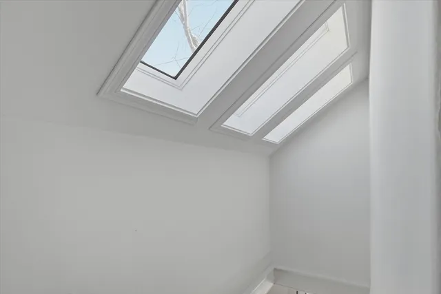 a view of staircase with white walls and door