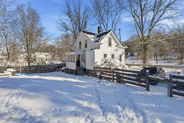 a view of a house with a snow in a yard