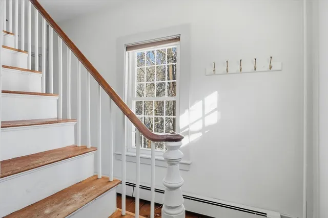 a view of entryway with wooden floor and stairs