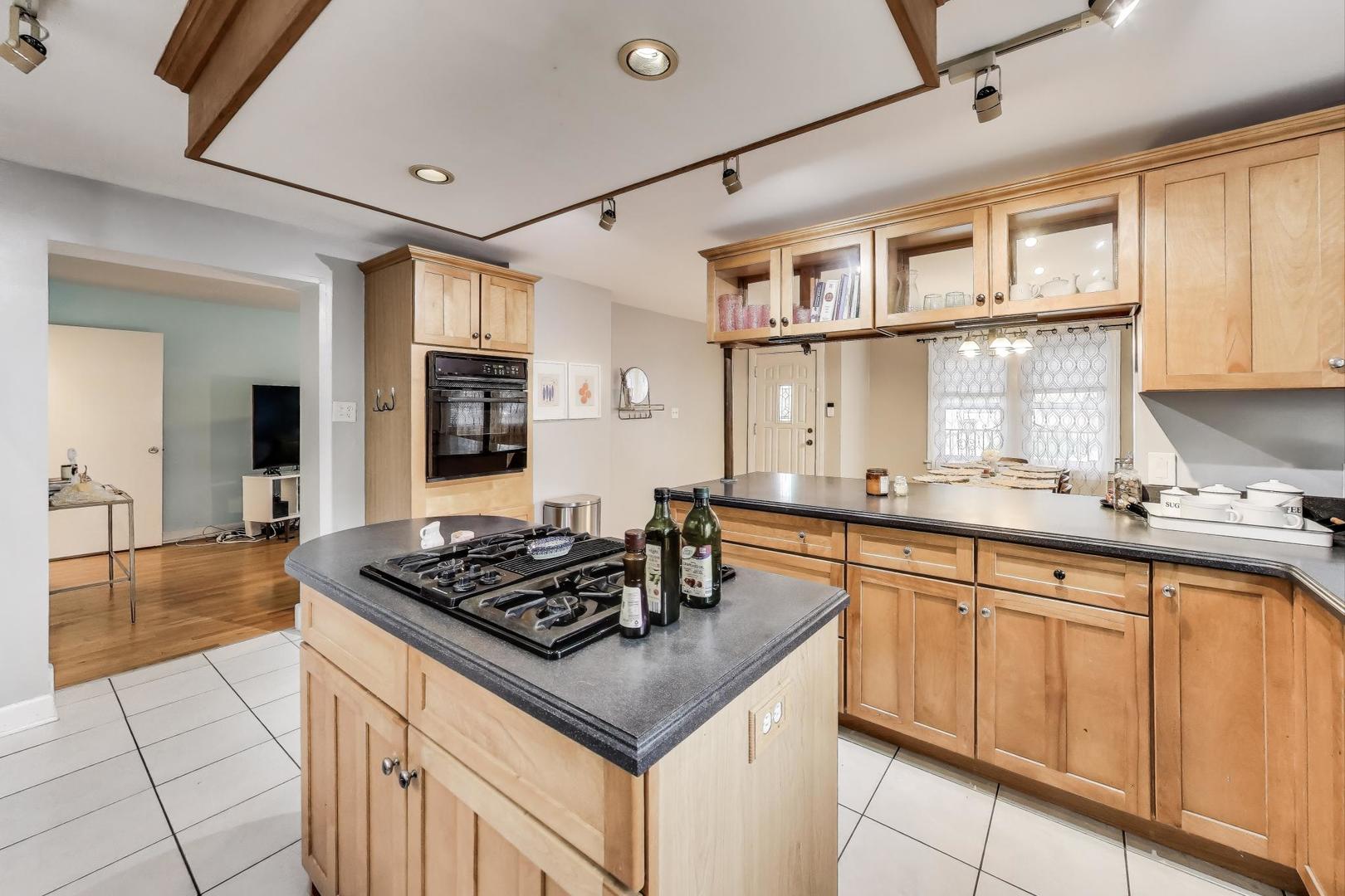 7401 West Main Street Niles, IL 60714 - Photo 13 of 37 a kitchen with stainless steel appliances a sink stove and cabinets