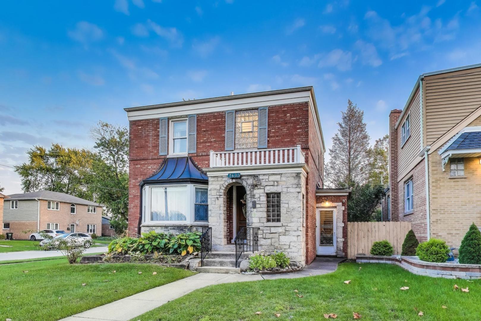 7401 West Main Street Niles, IL 60714 - Photo 2 of 37 a front view of a house with a garden and plants