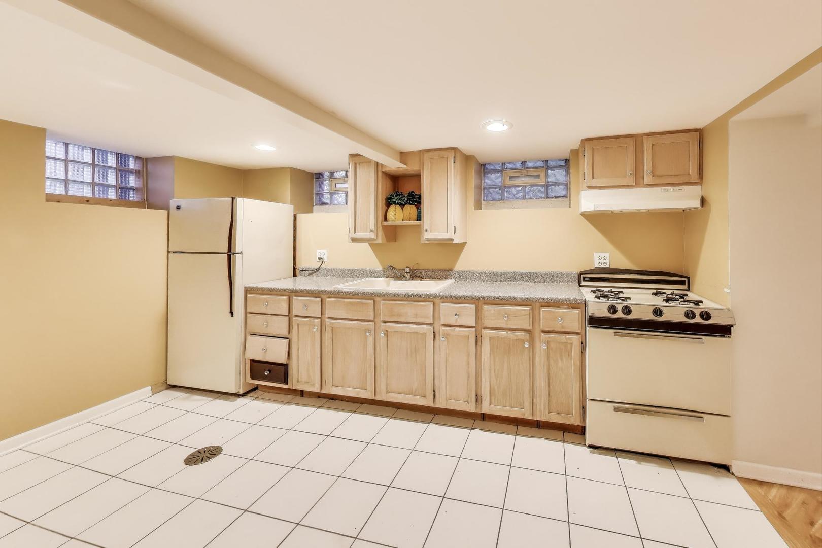 7401 West Main Street Niles, IL 60714 - Photo 26 of 37 a kitchen with stainless steel appliances a refrigerator sink and cabinets