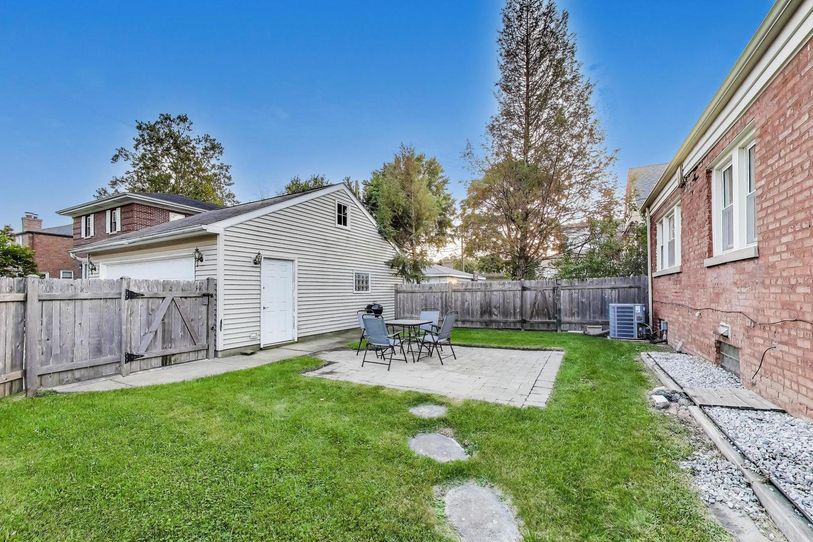 7401 West Main Street Niles, IL 60714 - Photo 34 of 37 a view of a chair and table in backyard of the house