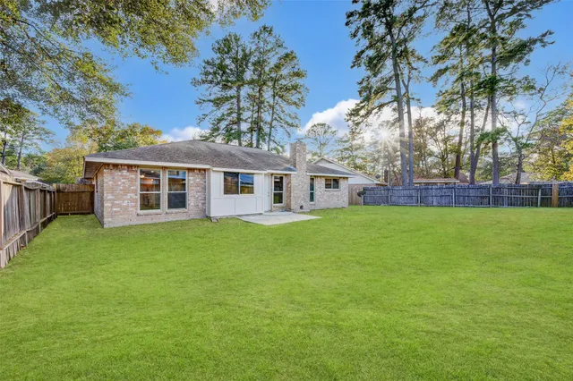 a view of a house with a backyard