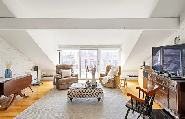 a living room with furniture wooden floor and a fireplace