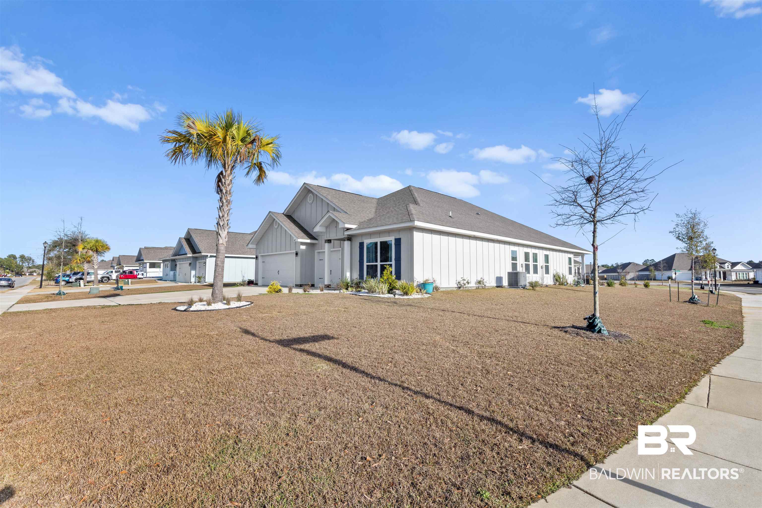 485 Shepard Street Gulf Shores, AL 36542 - Photo 42 of 53 View of side of property featuring board and batten siding, a residential view, and driveway