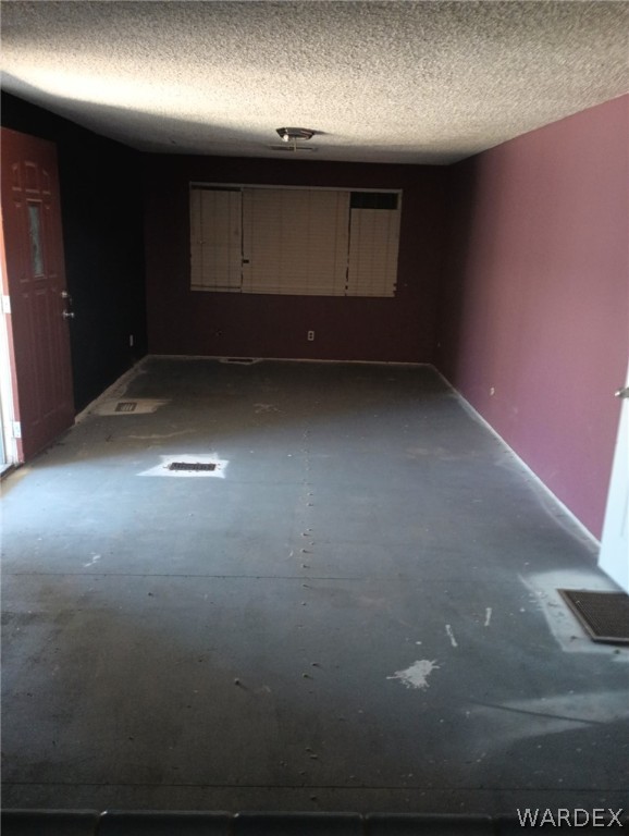 1083 Baseline Road Bullhead City, AZ 86442 - Photo 8 of 13 Empty room with a textured ceiling