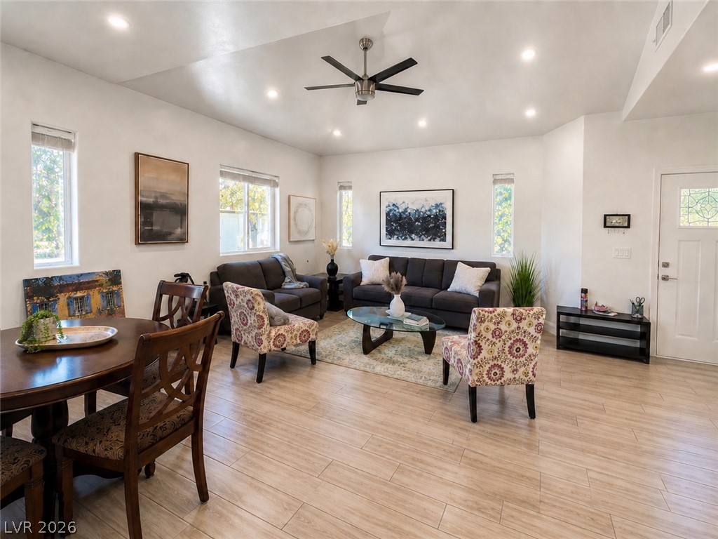 5446 Pine Ranch Street Las Vegas, NV 89113 - Photo 1 of 7 Smooth wood-look tile floors and clean plaster walls frame this inviting open-concept living space.