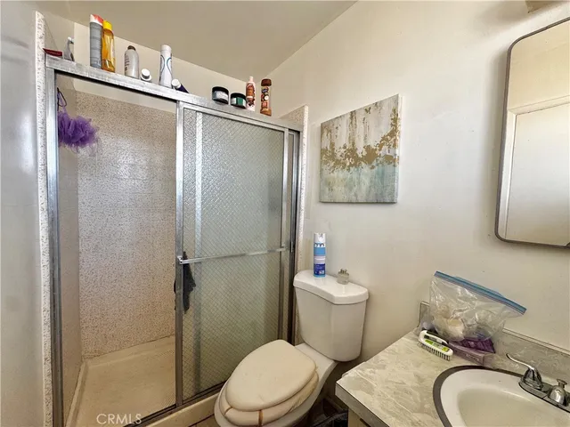a white toilet sitting next to a bathroom sink