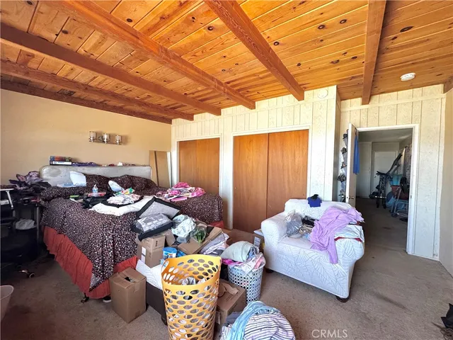 a bedroom with furniture and a chandelier