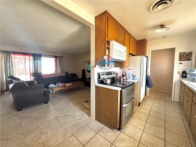 a kitchen with stainless steel appliances kitchen island granite countertop a refrigerator and a stove