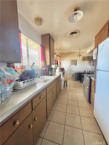 a kitchen with stainless steel appliances a sink counter space and a window