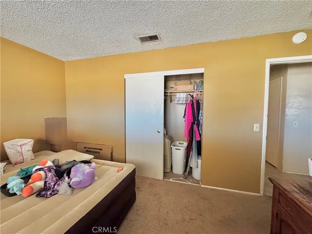 a bedroom with a bed and gym equipment