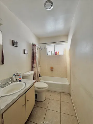 a bathroom with a sink a toilet and bathtub