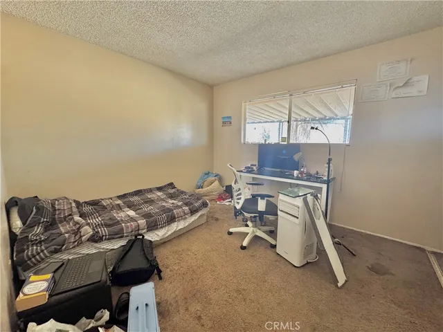 a bedroom with a bed and a chair
